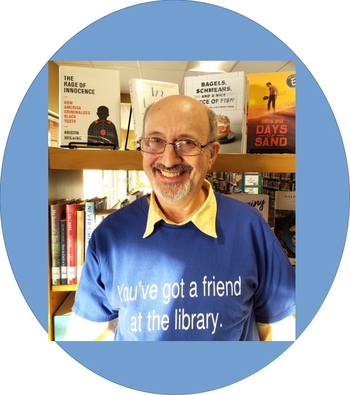 Smiling librarian standing in front of bookcase