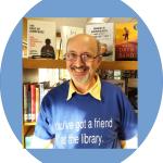 Smiling librarian standing in front of bookcase