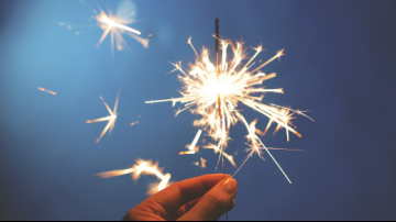 hand holding lit sparkler